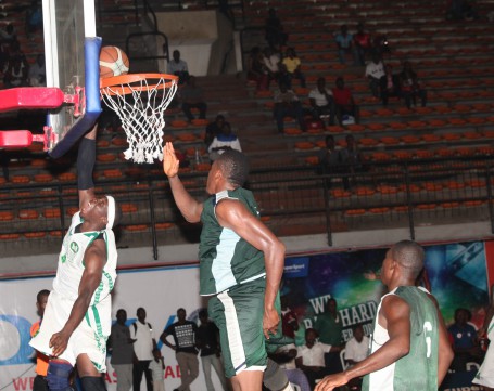 Adeola Olaiya in jersey No 9 of Kano Pillars going for a dunk against Plateau Peaks player during the 2014 Nigeria DStv Premier Basketball League Final 8 held at the Indoor Sports Hall of National Stadium, Surulere. Kano Pillars won by94-53 points