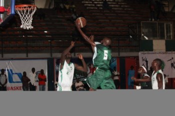 Prewet Gagara in jersey No 5 of Plateau Peaks going for a dunk against Kano Pillars player during the 2014 Nigeria DStv Premier Basketball League Final 8
