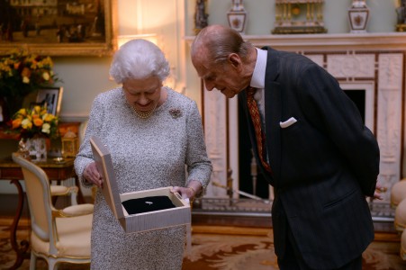 Queen Elizabeth II and the Duke of Edinburgh, look at the Federation Equestre Internationale (FEI) lifetime achievement award for her devotion to equestrian sport, presented to her by Princess Haya of Jordan and Keith Taylor, President of the British National Equestrian Federation, at Buckingham Palace, London. PRESS ASSOCIATION Photo. Picture date: Wednesday November 26, 2014. Photo credit: Anthony Devlin/PA Wire