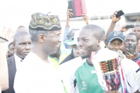 Cowrie RFC Captain Azeez Ladipo Receiving the winner's Trophy from then Governor of Lagos State Babatunde Fashola