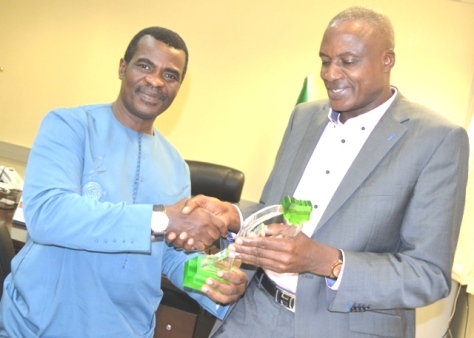 A Member of the Award Panel,Nigerian Sports Award, Mitchel Obi, presenting an award to the Director General, National Sports Commission, Al-Hassan Yakmut in Abuja recently.