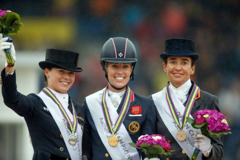 The Grand Prix Freestyle medallists on the podium at the FEI European Dressage Championships 2015 in Aachen, Germany today. (L to R) Kristina Bröring-Sprehe from Germany (silver), Britain’s Charlotte Dujardin (gold) and Spain’s Beatriz Ferrer-Salat (bronze). (FEI/Dirk Caremans)