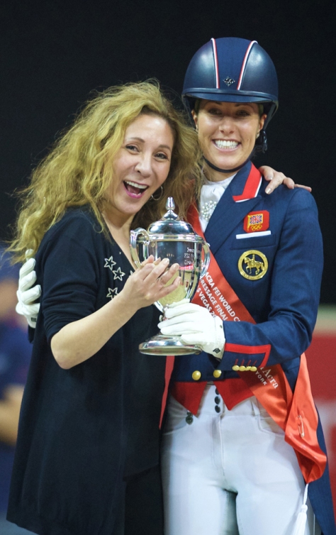 New York fashion designer Reem Acra hugs champion Charlotte Dujardin after the British rider and her wonderhorse Valegro successfully defended their title at the Reem Acra FEI World Cup™ Dressage Final 2014/2015 in Las Vegas (USA) last April. (FEI/Arnd Bronkhorst)