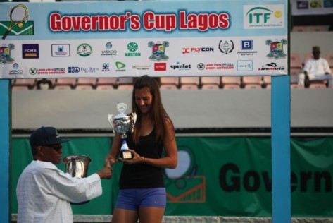 Chairman of LOC, Pius Akinyelure (left) presents trophy to   women's singles winner, Conny Perrin of Switzerland