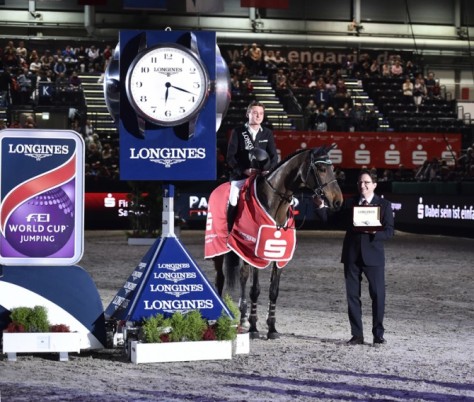 New German sensation, 22-year-old Niklas Krieg, was the surprise winner of today’s ninth leg of the Longines FEI World Cup™ Jumping 2015/2016 Western European League at Leipzig (GER). He is pictured receiving the winner’s Longines watch from Mr Rainer Eckert, Longines Brand Manager for Germany. (FEI/Karl-Heinz Frieler) 